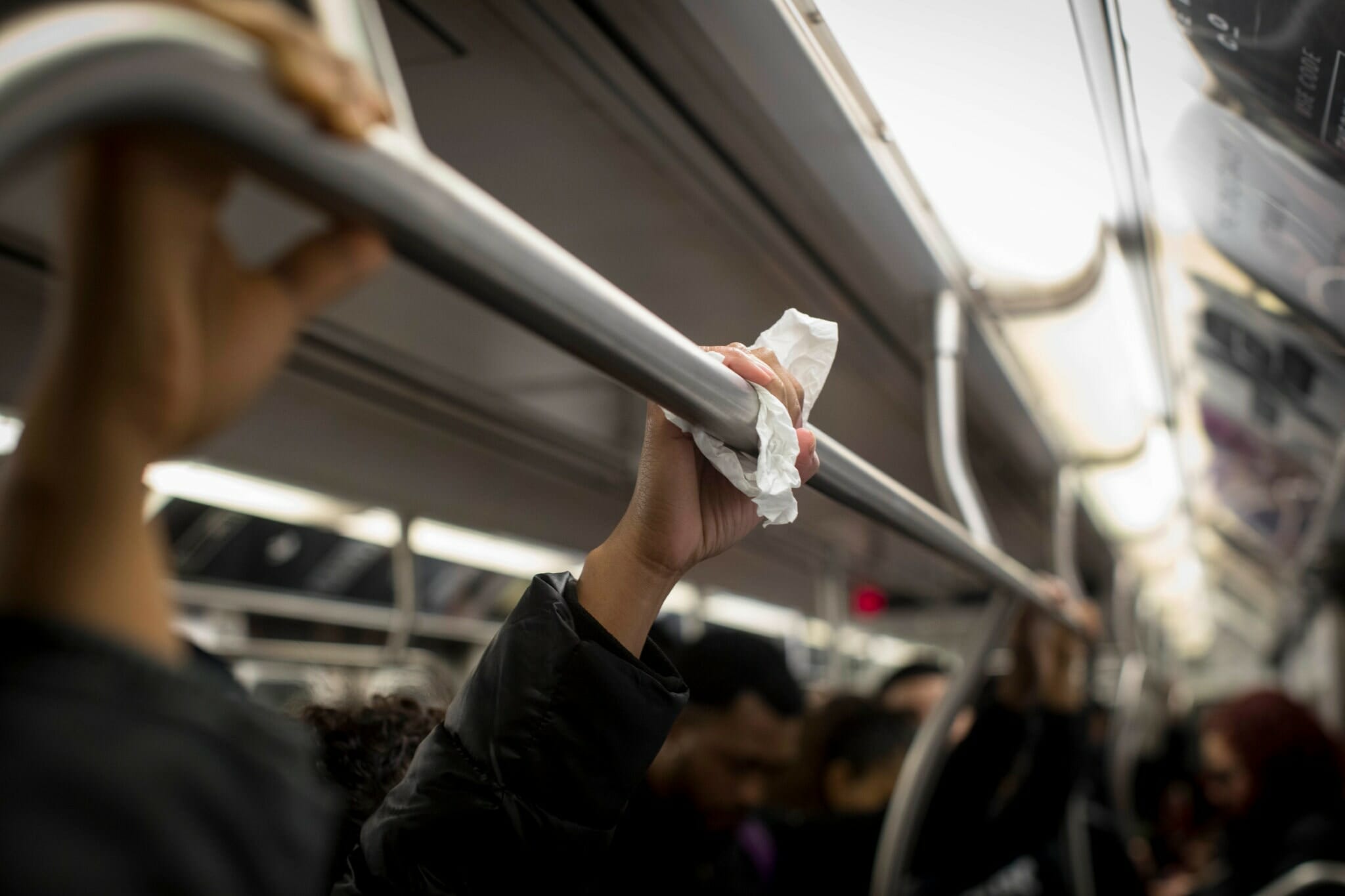 hands on subway poles